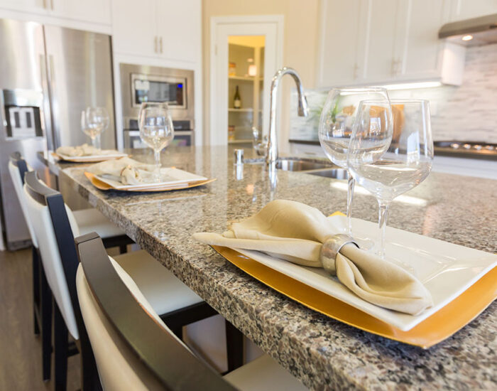 Abstract of Beautiful Kitchen Granite Counter Place Settings and Chairs.