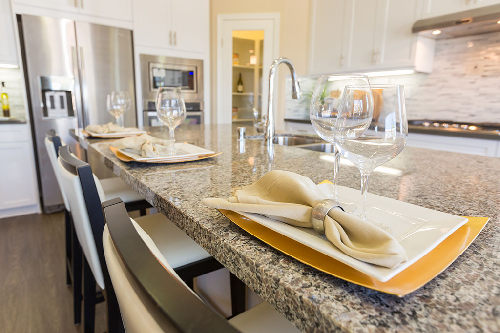 Abstract of Beautiful Kitchen Granite Counter Place Settings and Chairs.